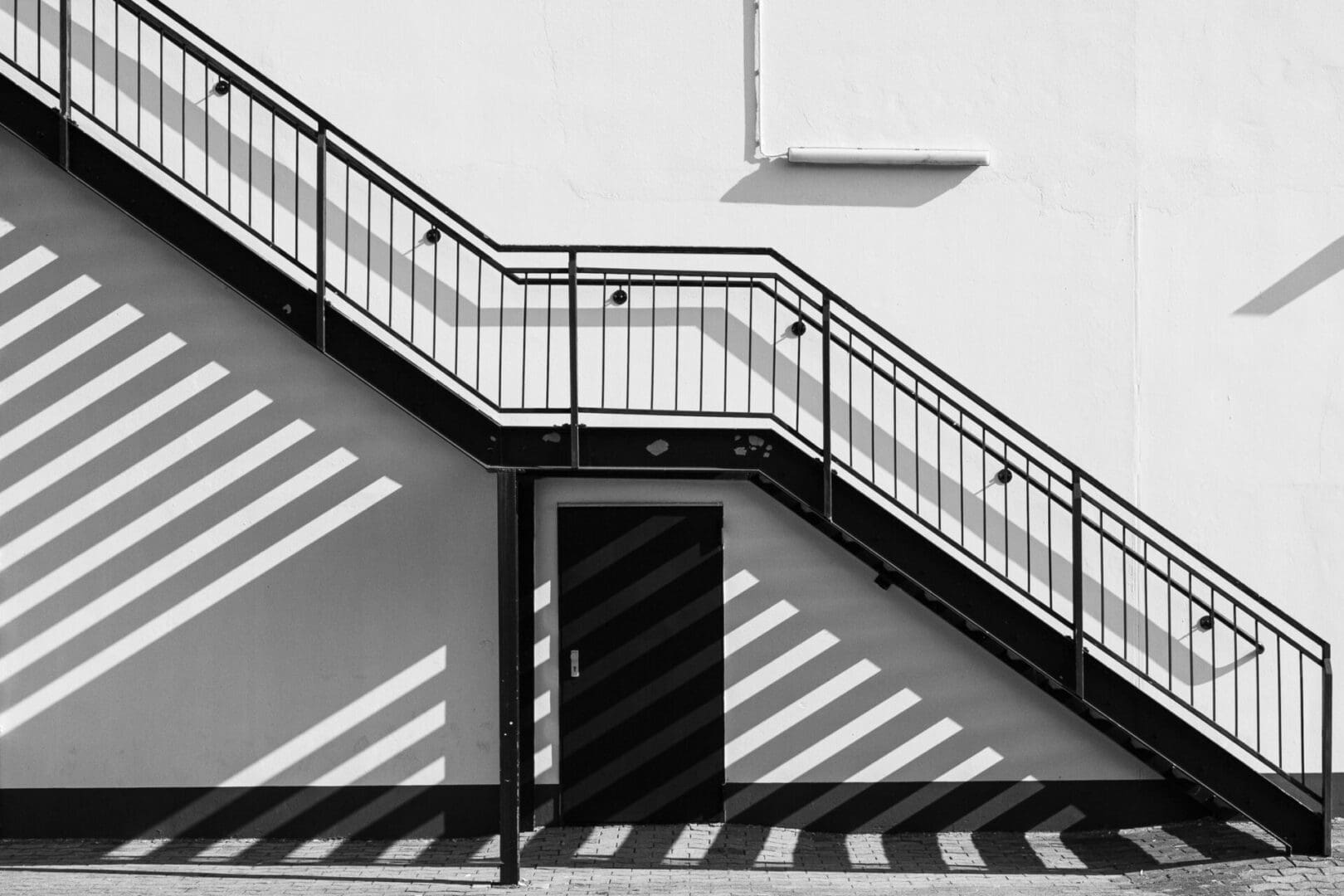 A black and white photo of stairs leading to the top.