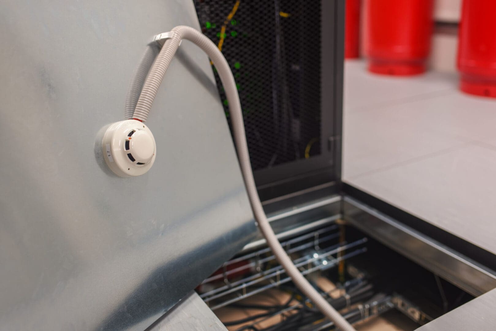 A white cord hanging from the side of an oven.