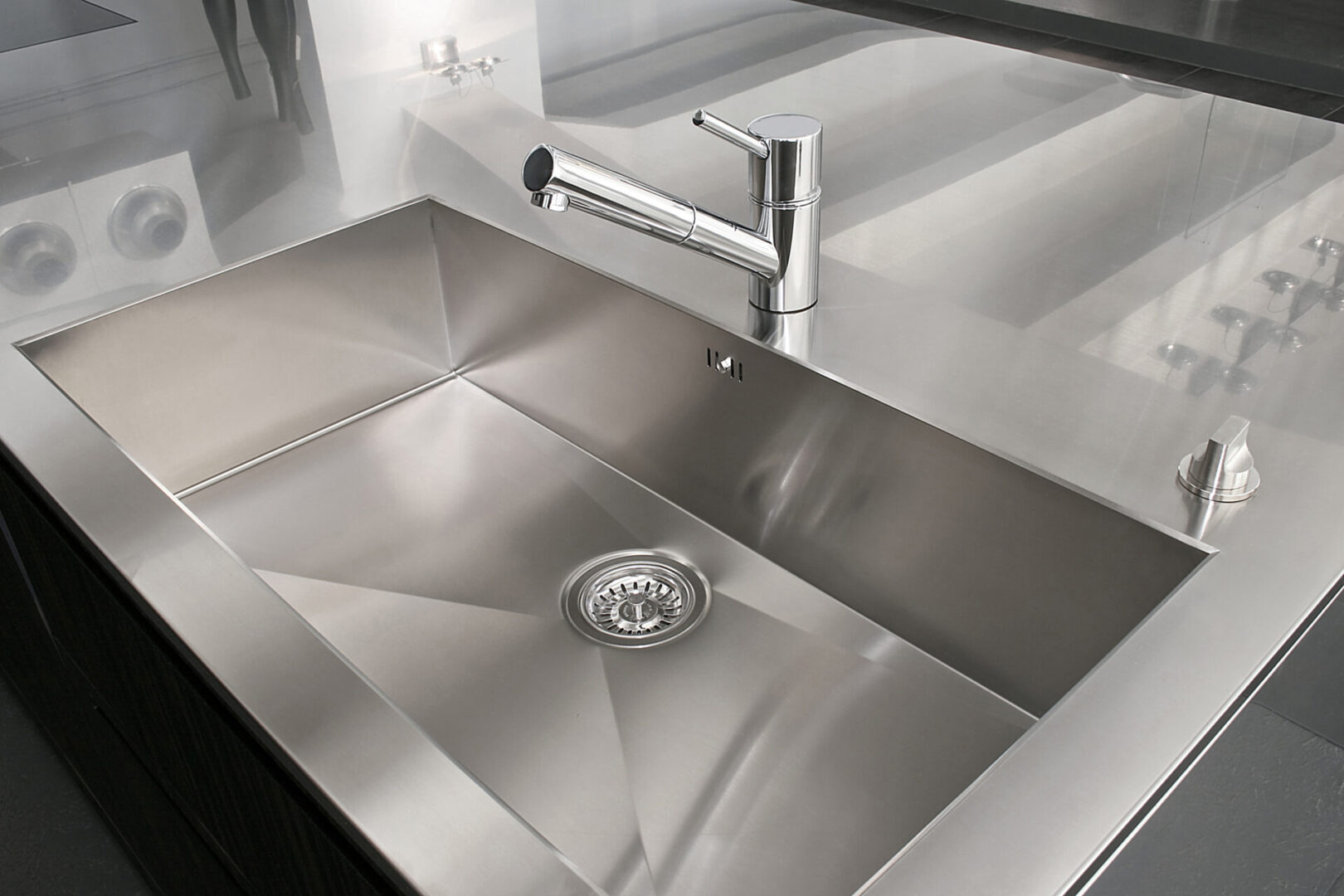 A stainless steel sink with a chrome faucet.