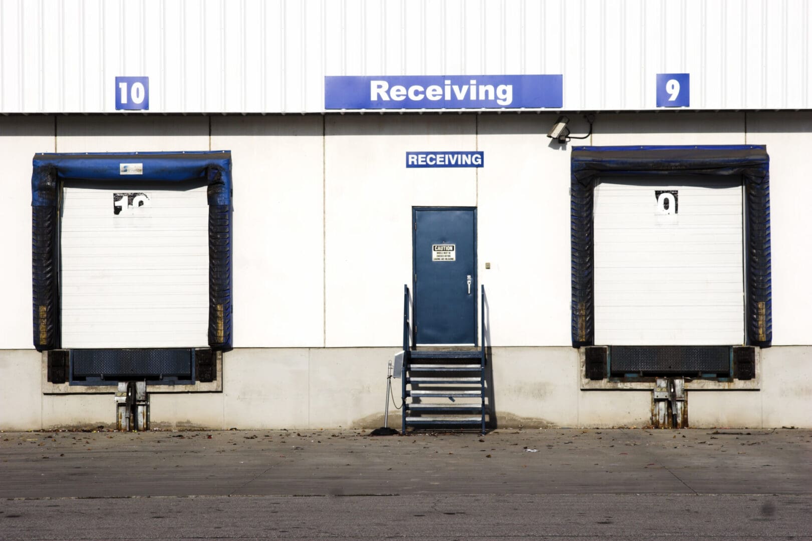 A building with two large doors and one door open.