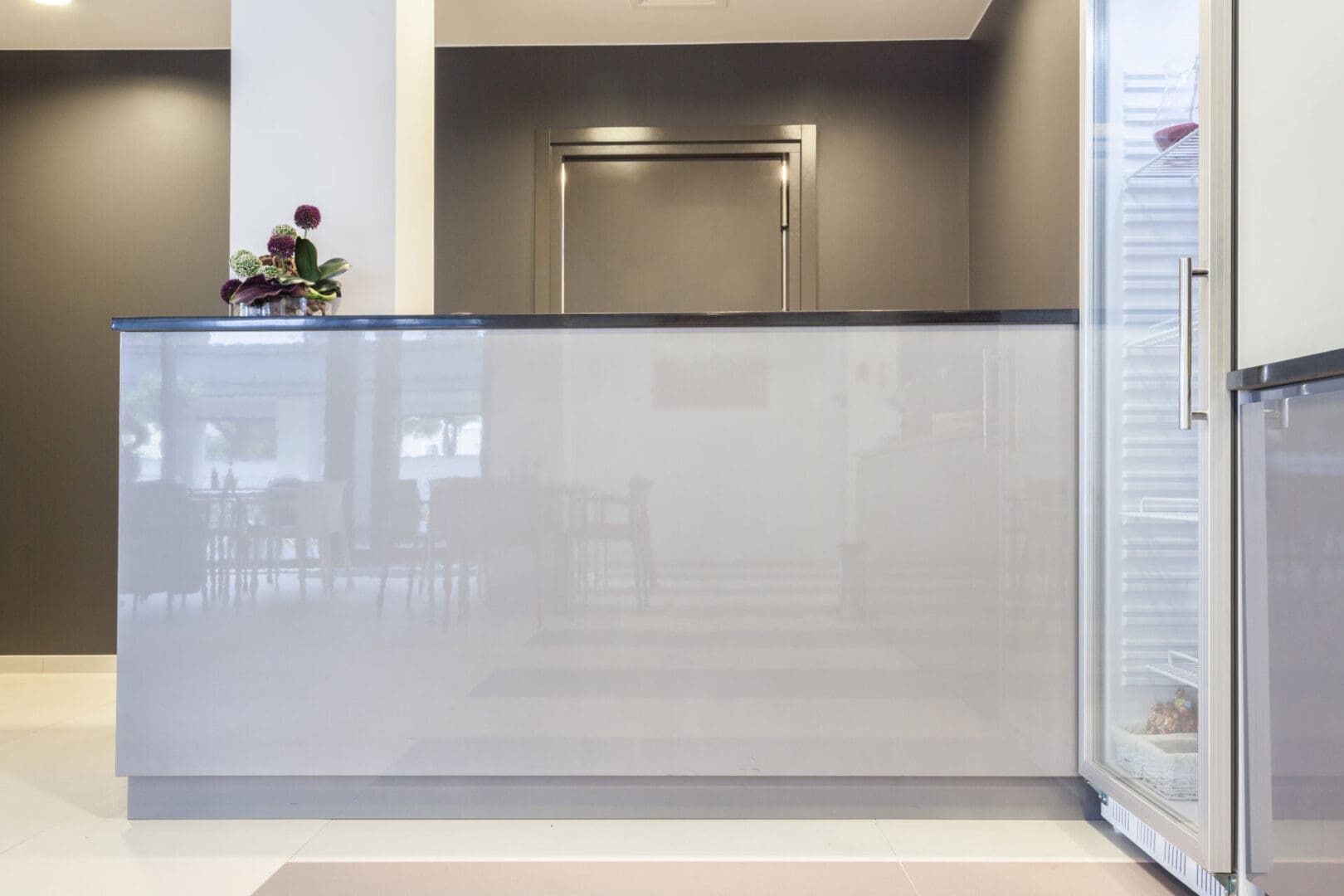 A glass wall with a door open to the outside.