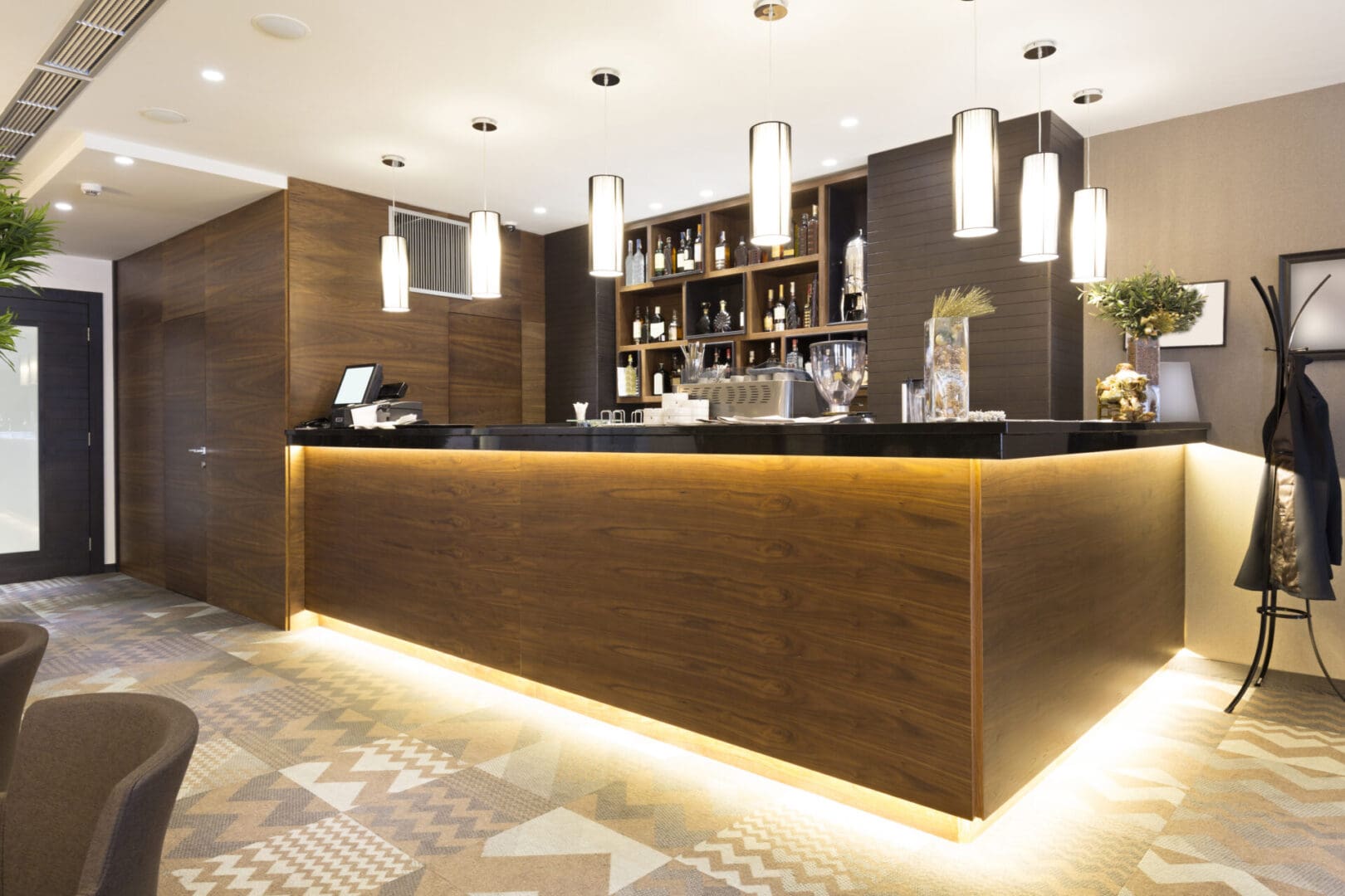 A bar with lights on the ceiling and walls.