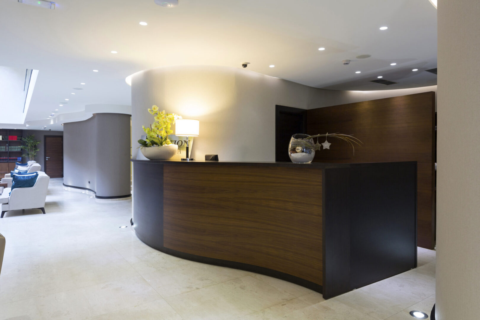 A reception desk with lights on the wall.