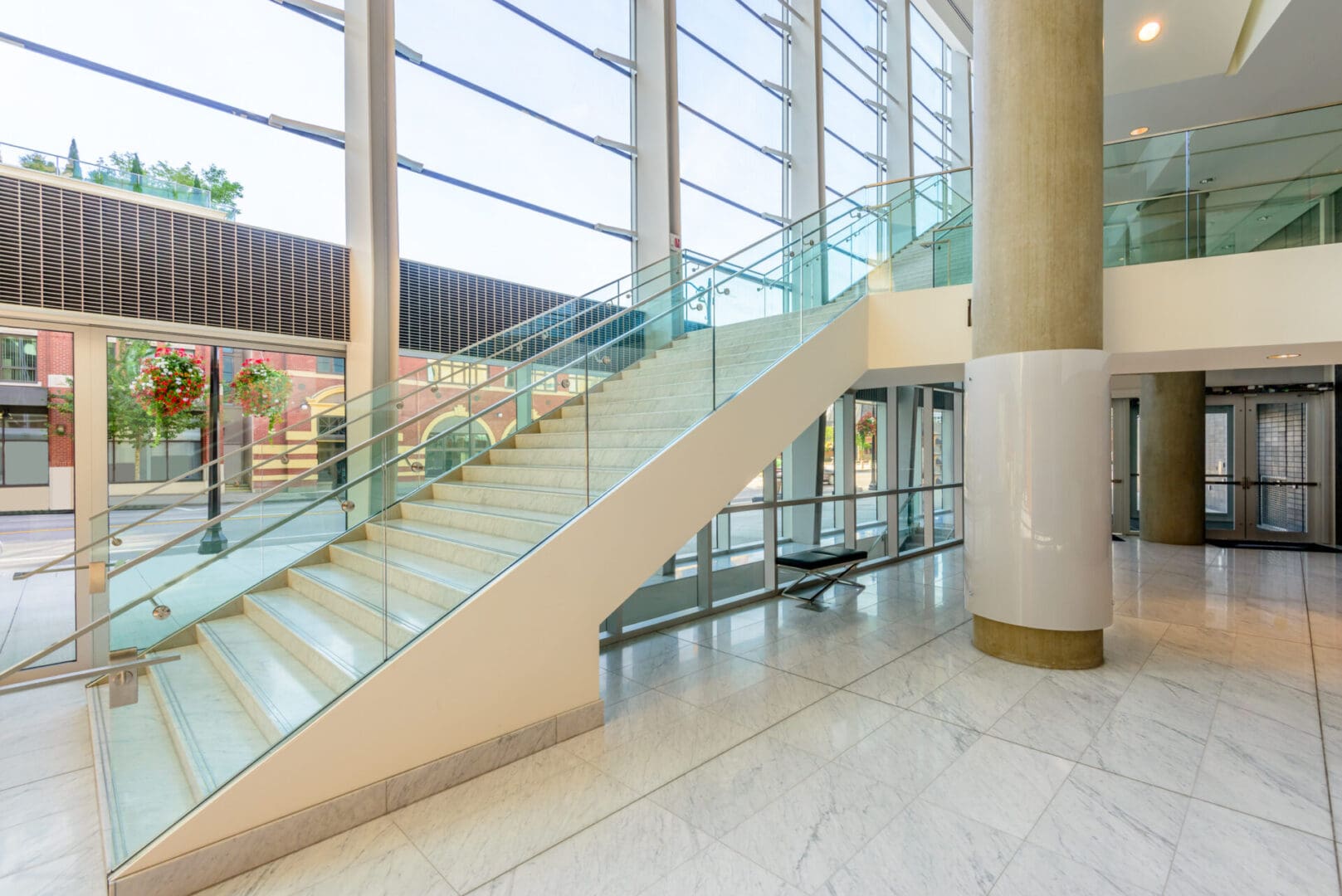 A large glass staircase in the middle of a building.