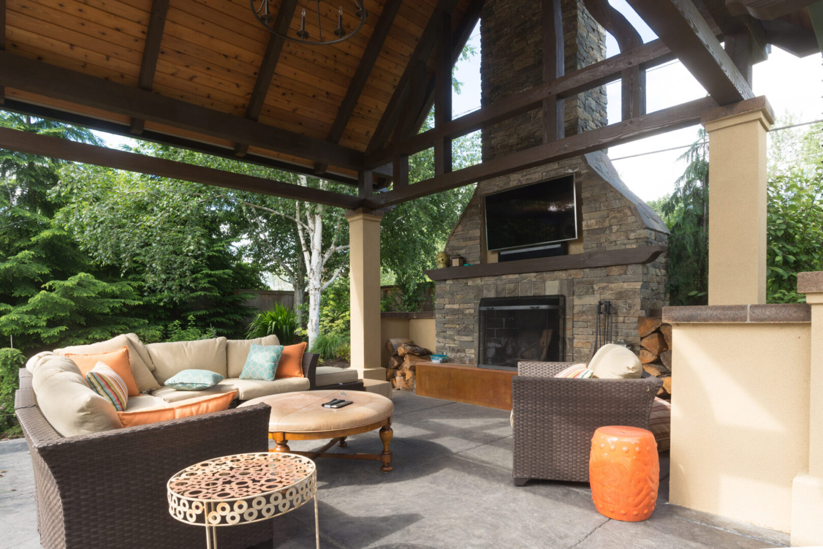 A large outdoor living room with a fireplace.