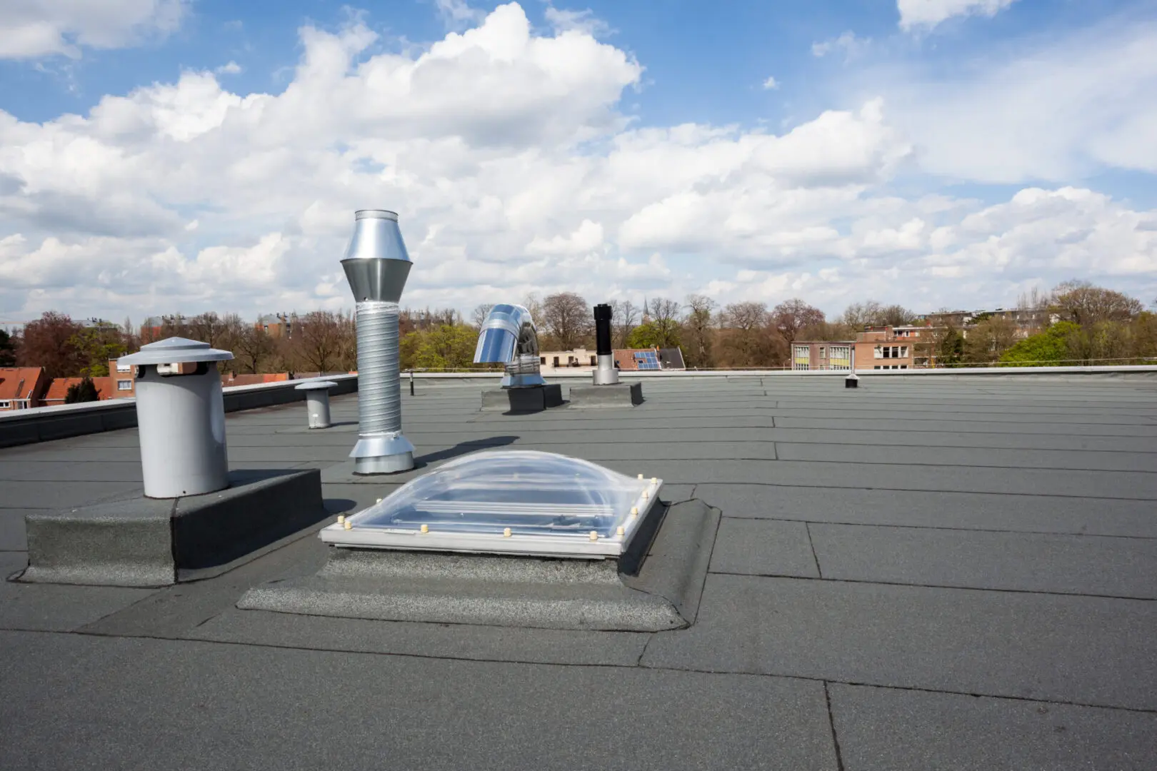 A roof with a sky background and some trees