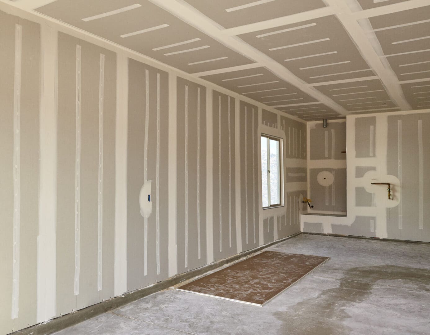 Construction,Building,Industry,New,Home,Construction,Interior,Drywall,Tape,And A room with white walls and carpet in it