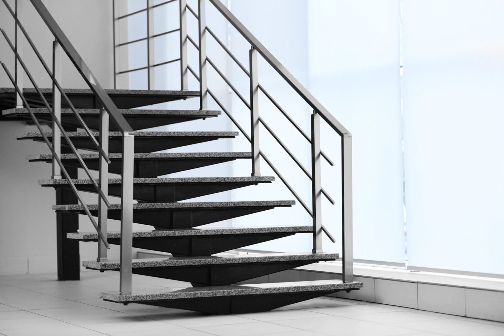 A staircase with metal railing and steps.