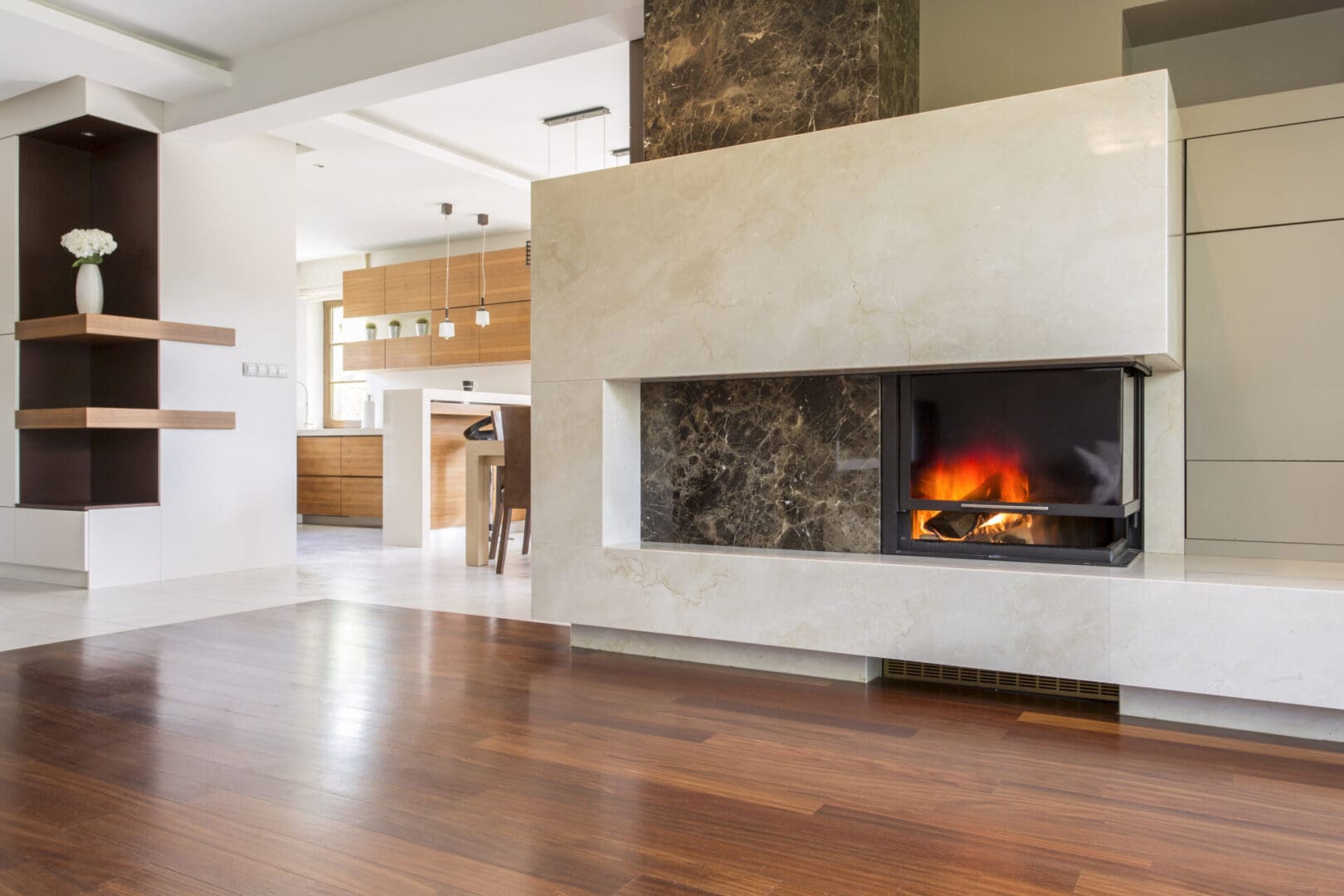 A living room with wood floors and fireplace.