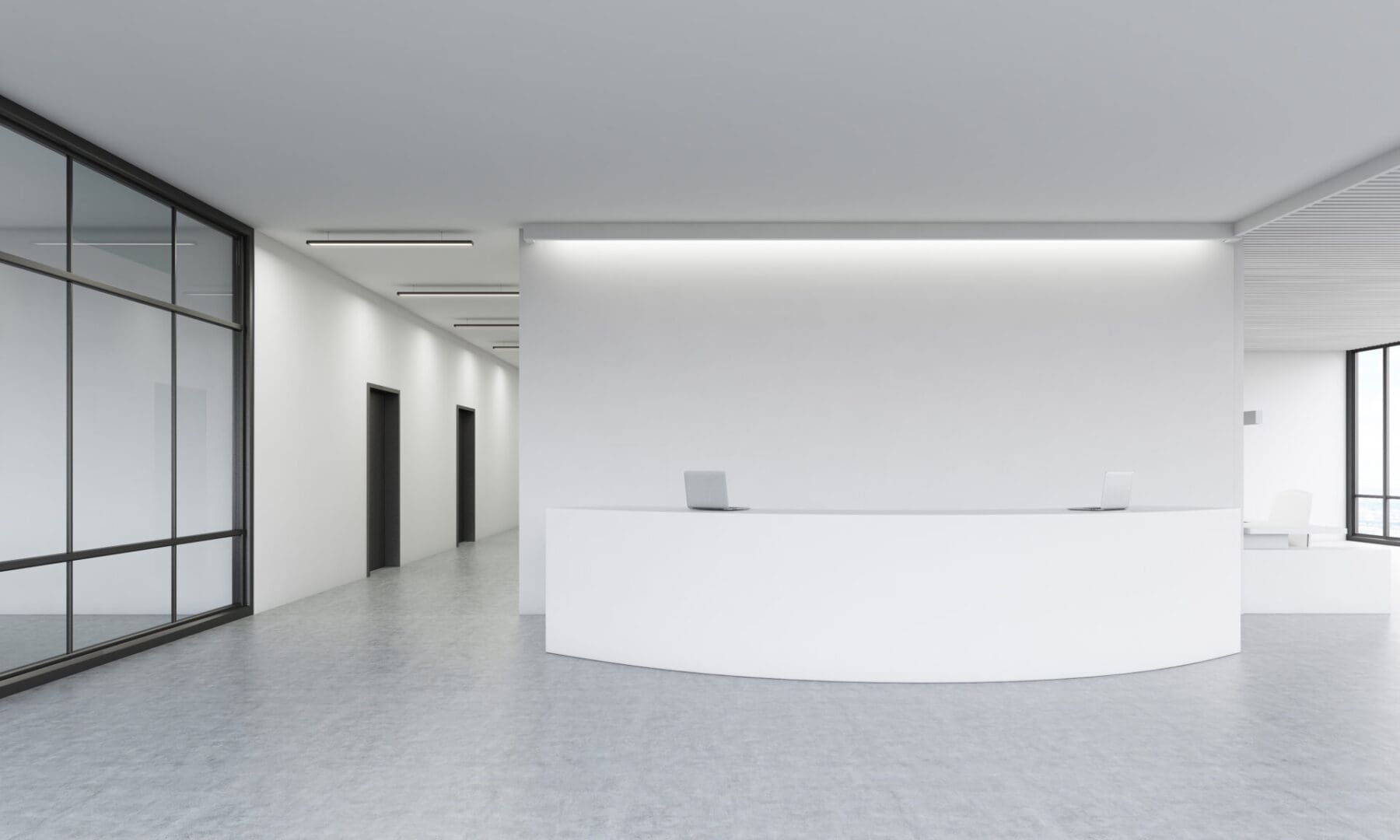 A white lobby with two black doors and a reception desk.