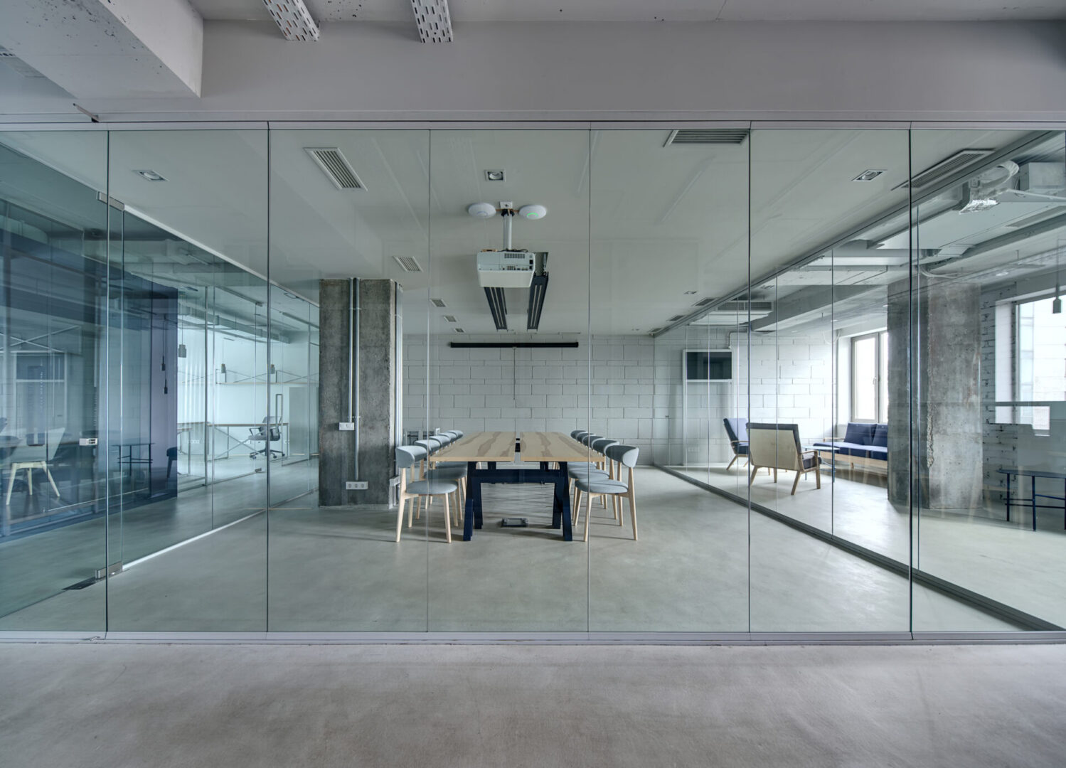 A room with glass walls and a table in the middle.