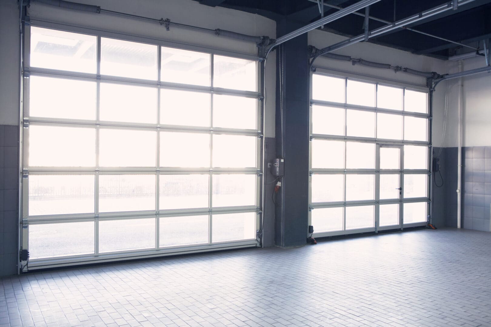 A garage door that is open and has some windows.