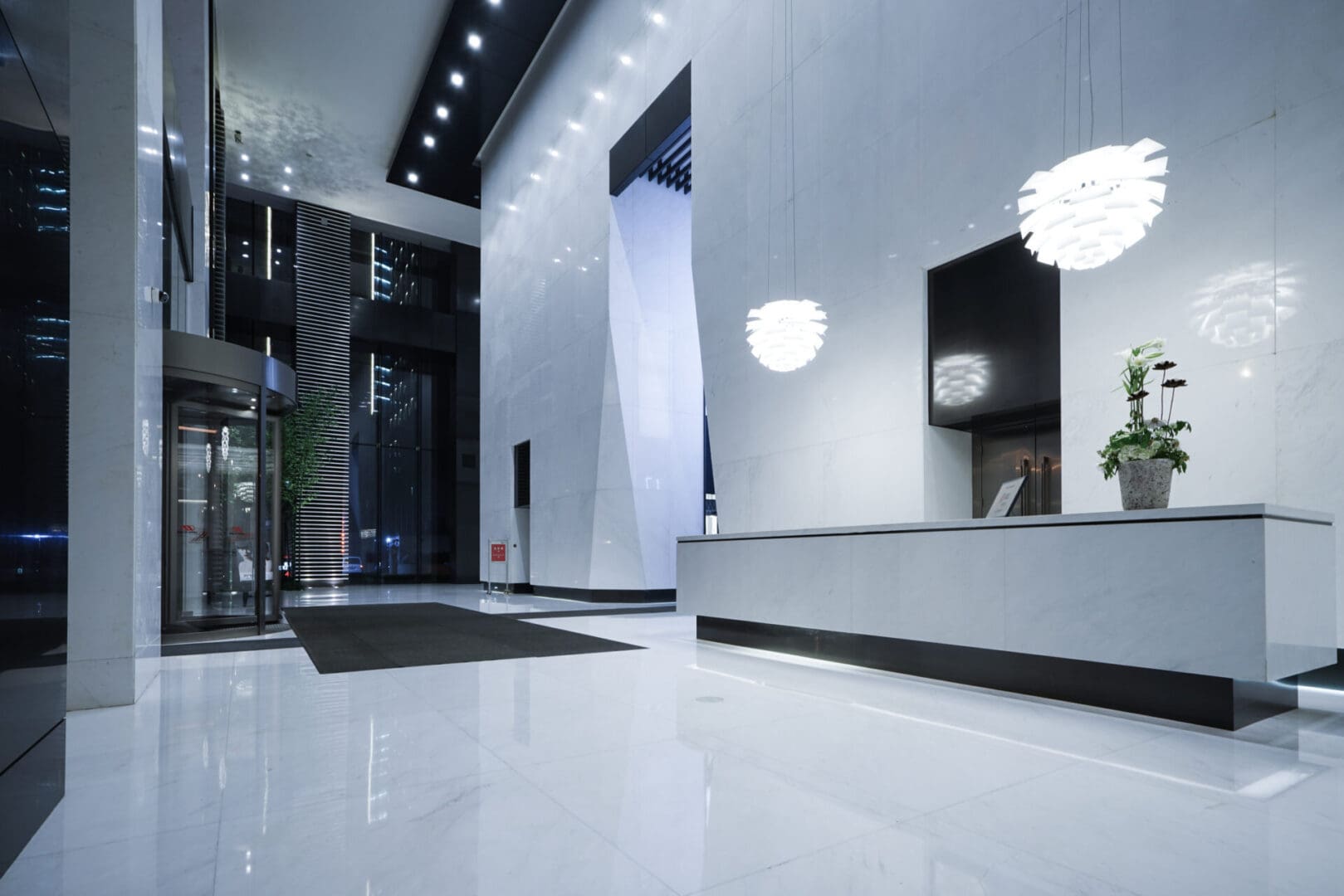 A lobby with white tile floors and walls.