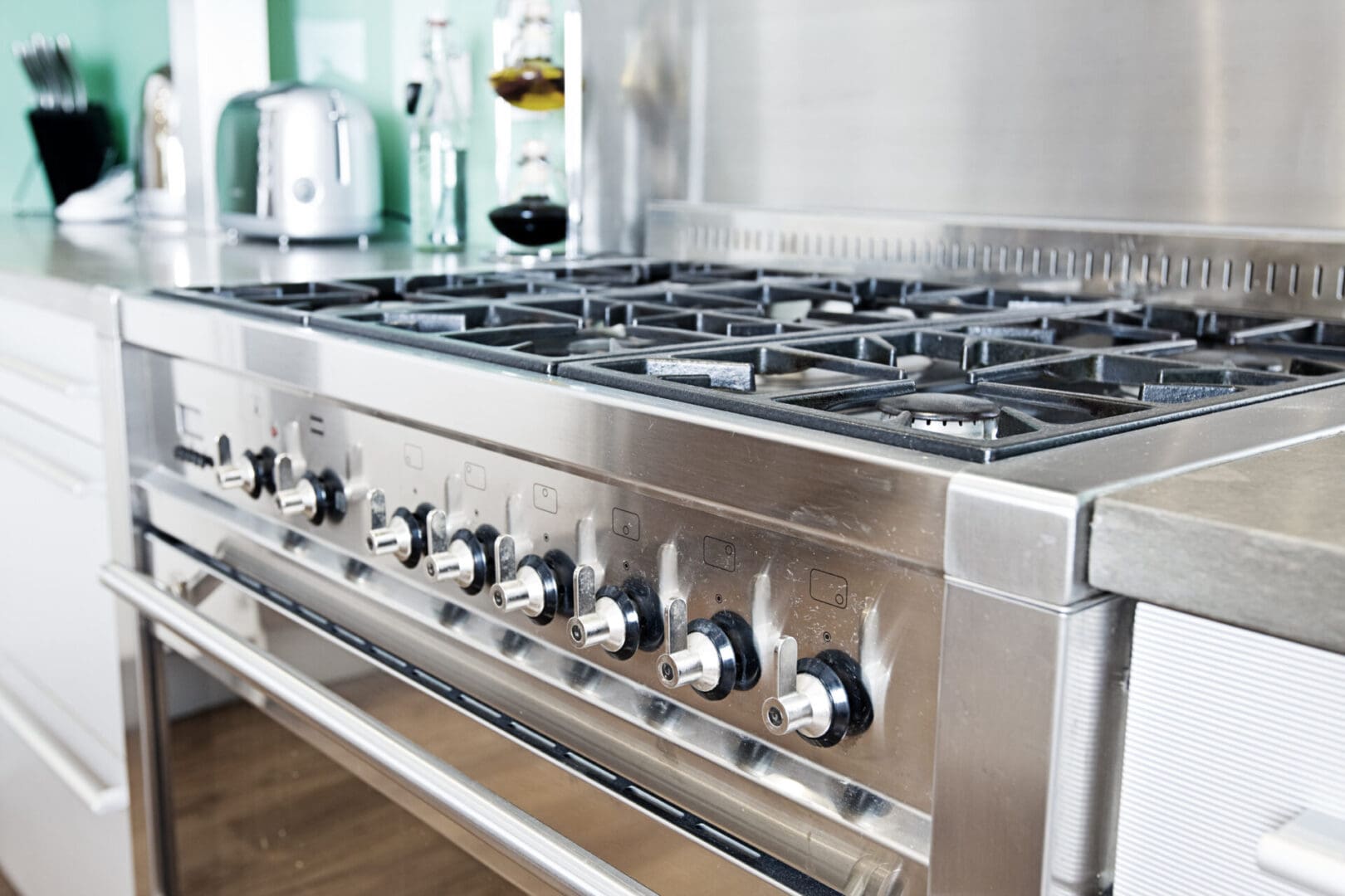 A large stainless steel stove with black knobs.