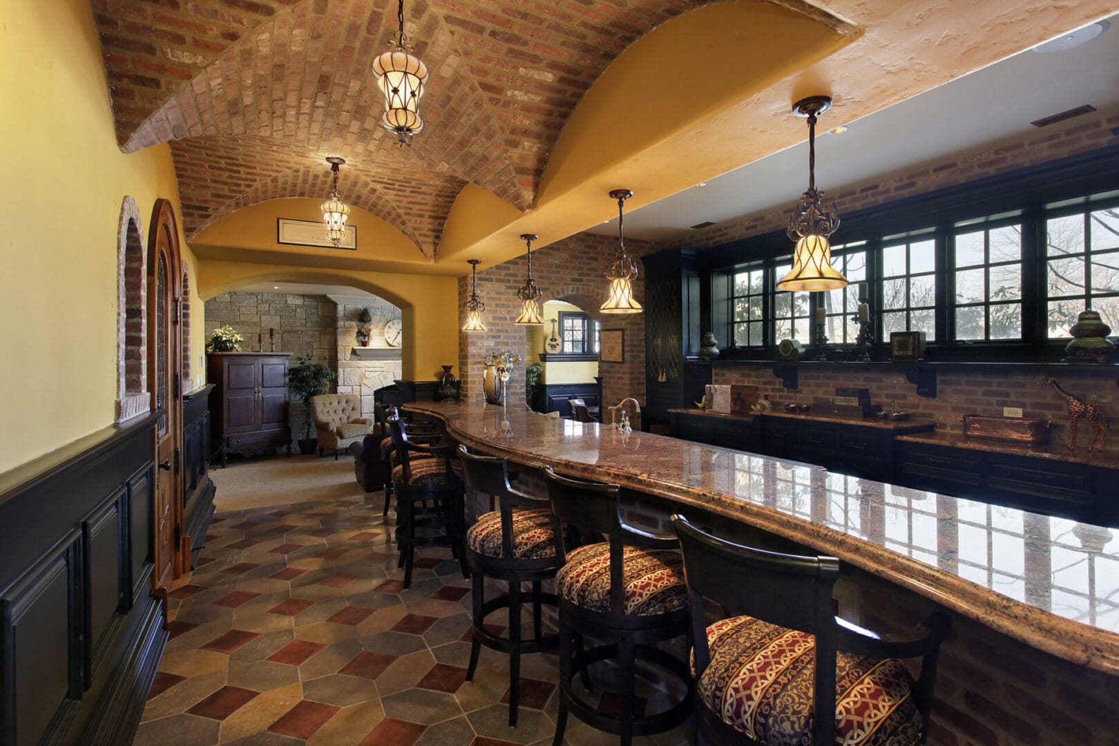 A bar with several chairs and tables in it.