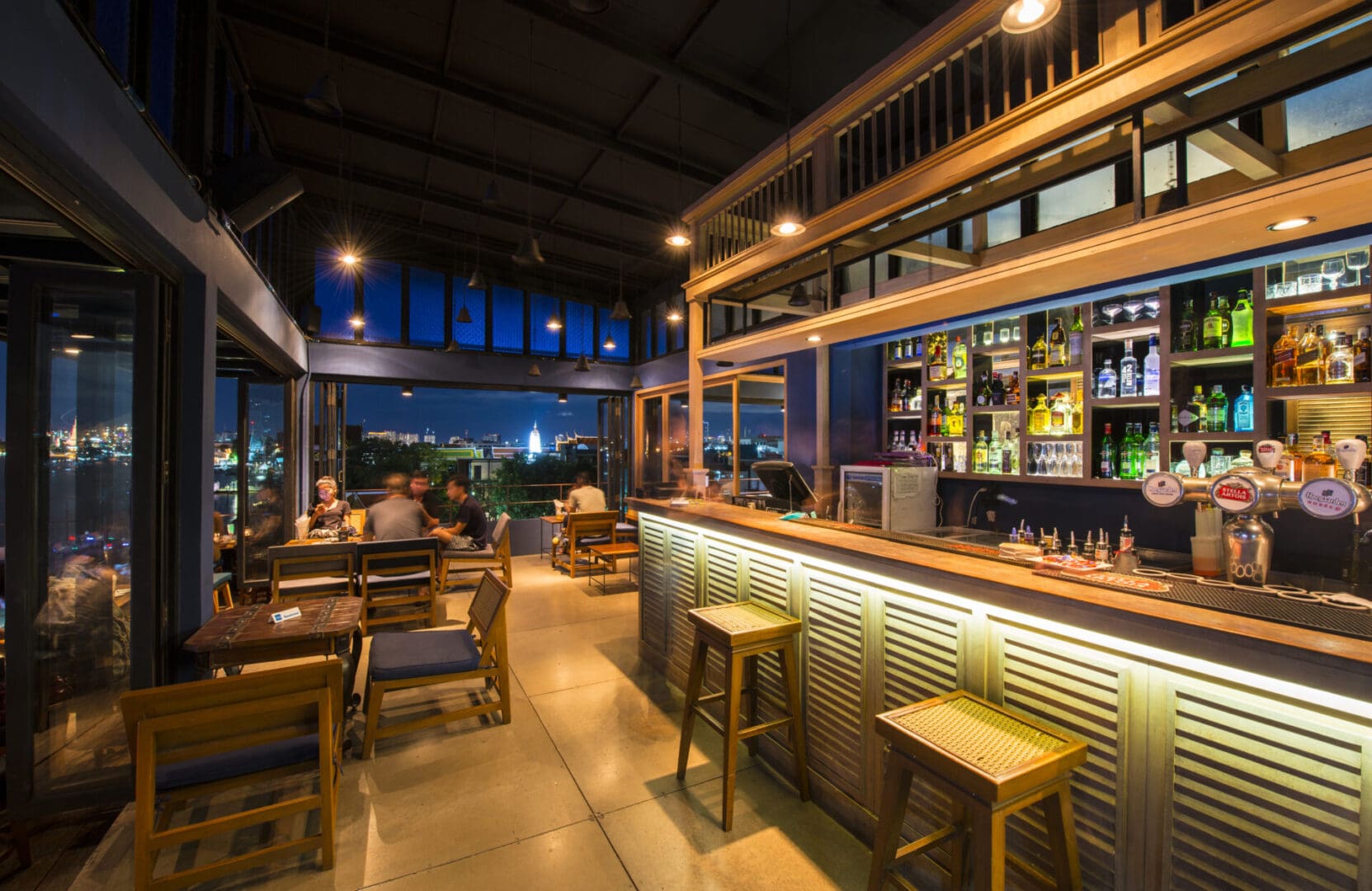 A bar with chairs and tables in it