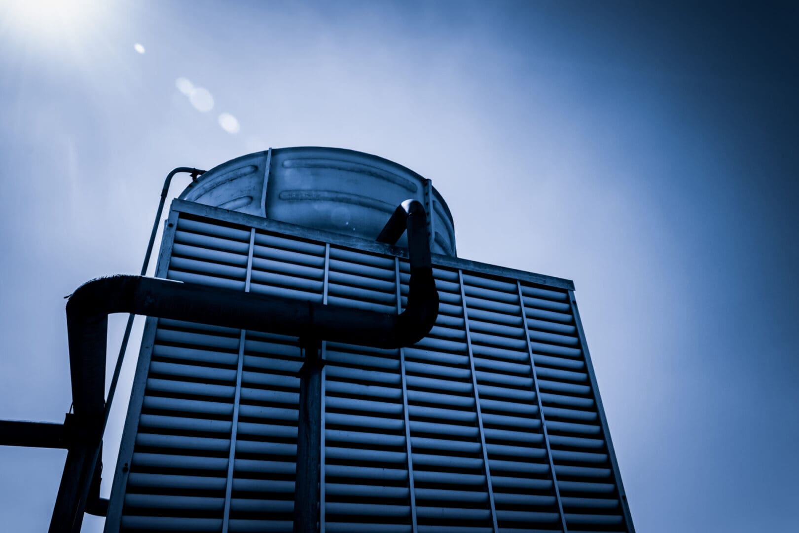 A building with a sky background and a pipe