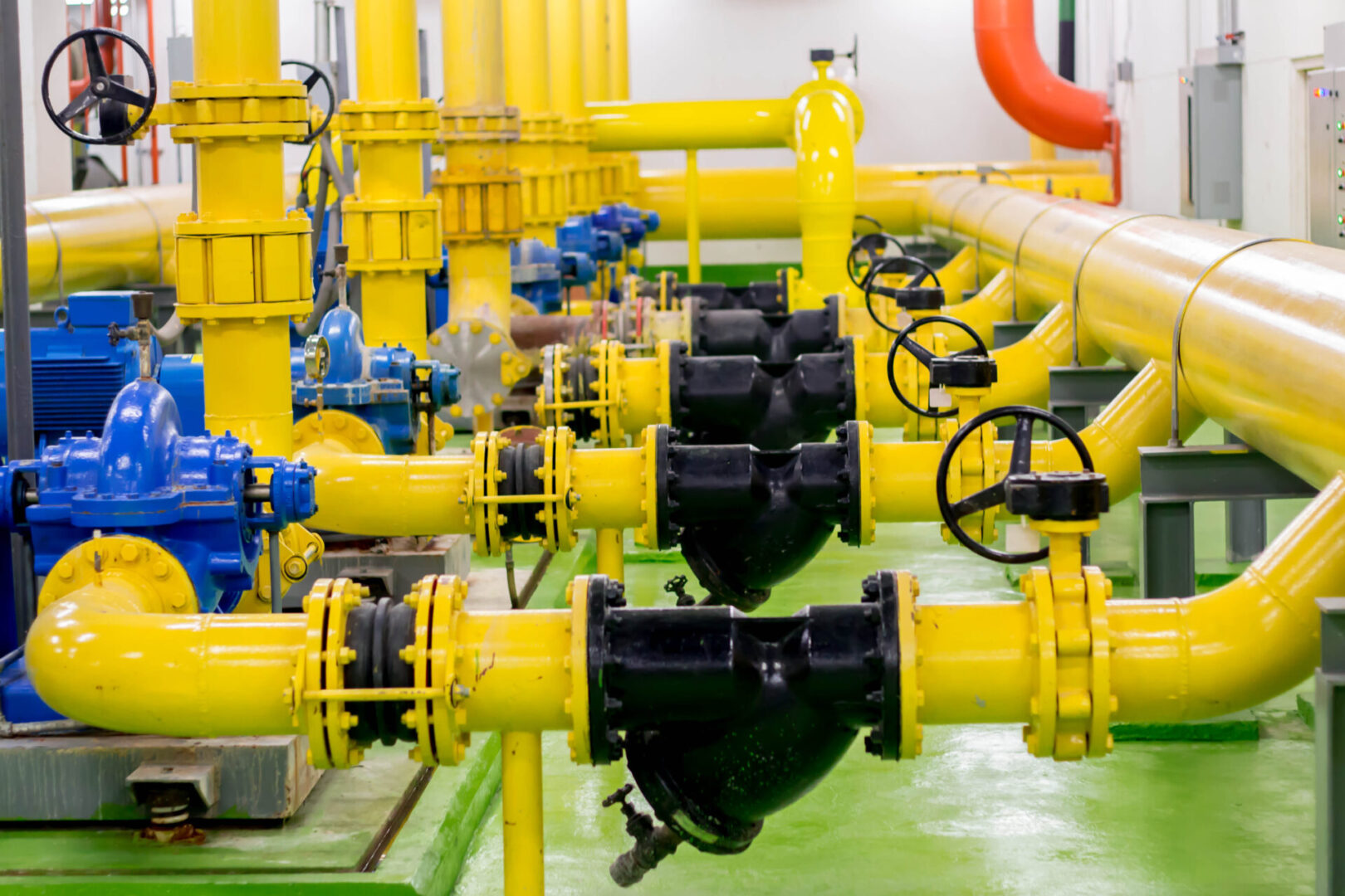 A yellow and blue gas pipeline with valves.