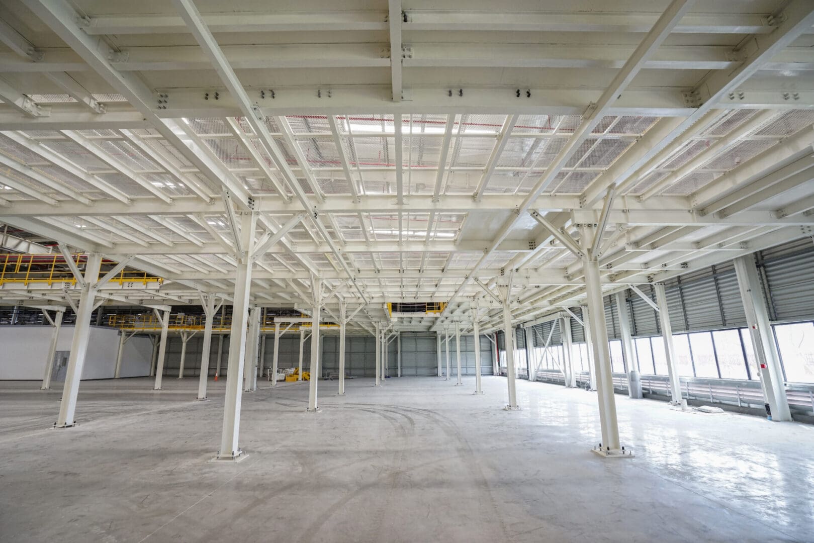 A large empty warehouse with lots of white beams.