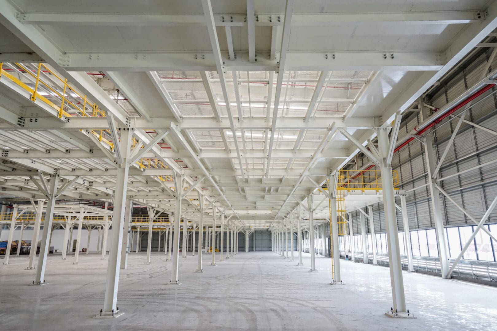 A large empty warehouse with lots of white beams.