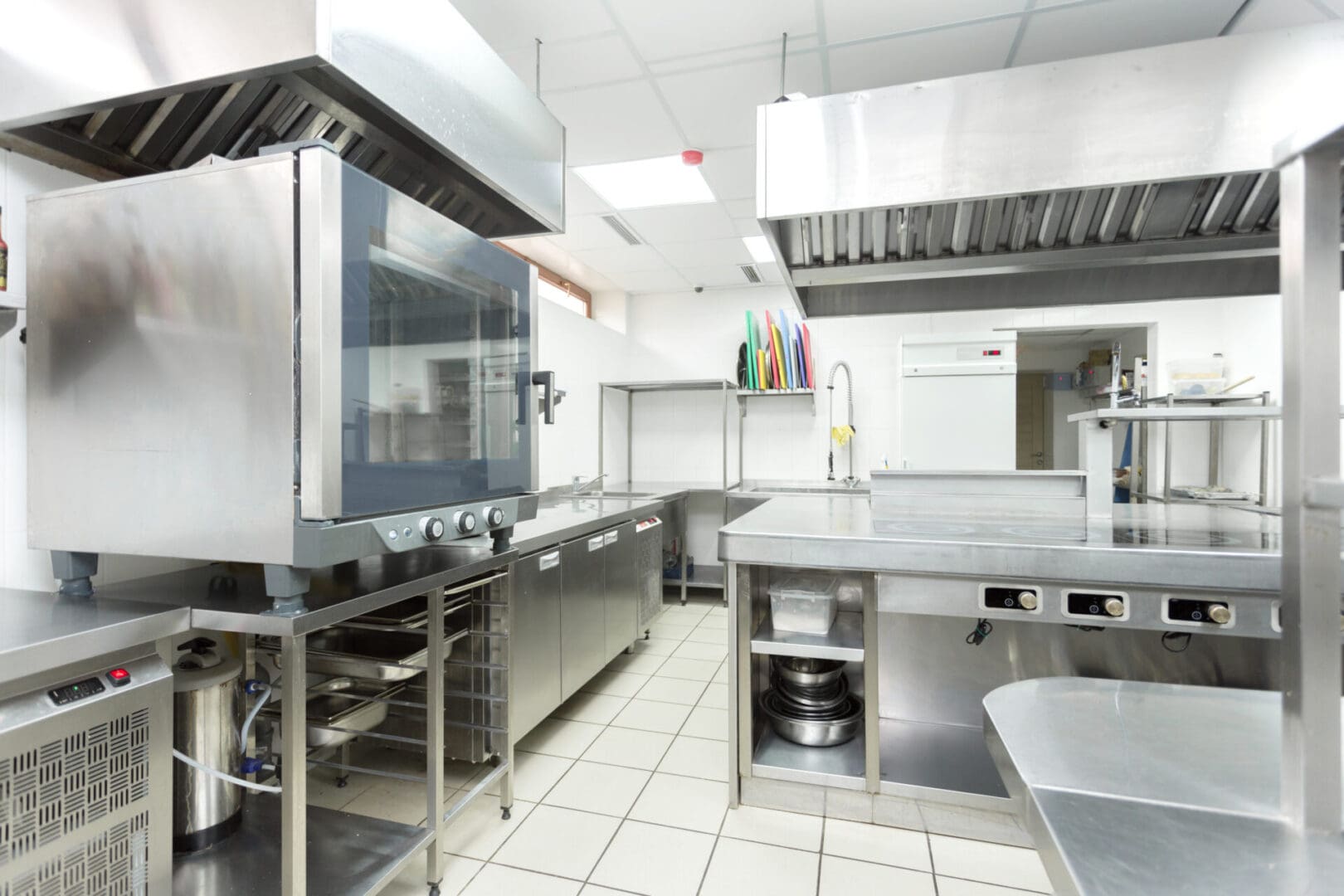 A kitchen with many stainless steel appliances and counters.