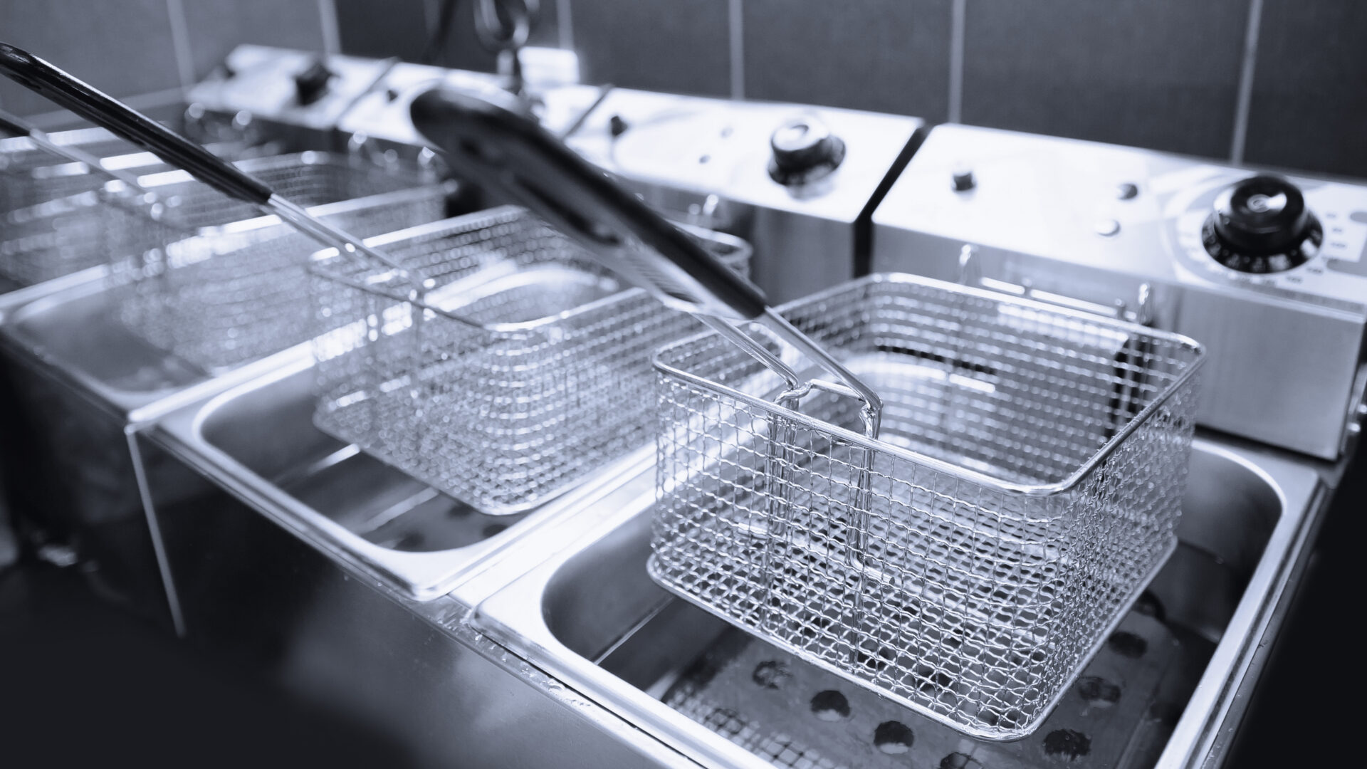 A row of baskets in an industrial kitchen.