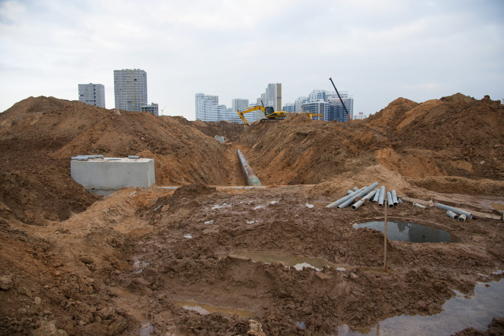 A construction site with many piles of dirt.