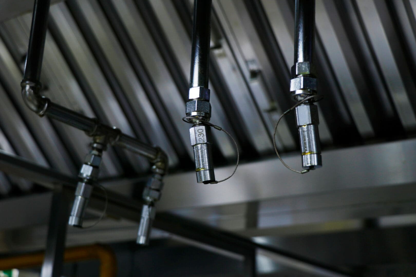 A close up of some pipes hanging from the ceiling