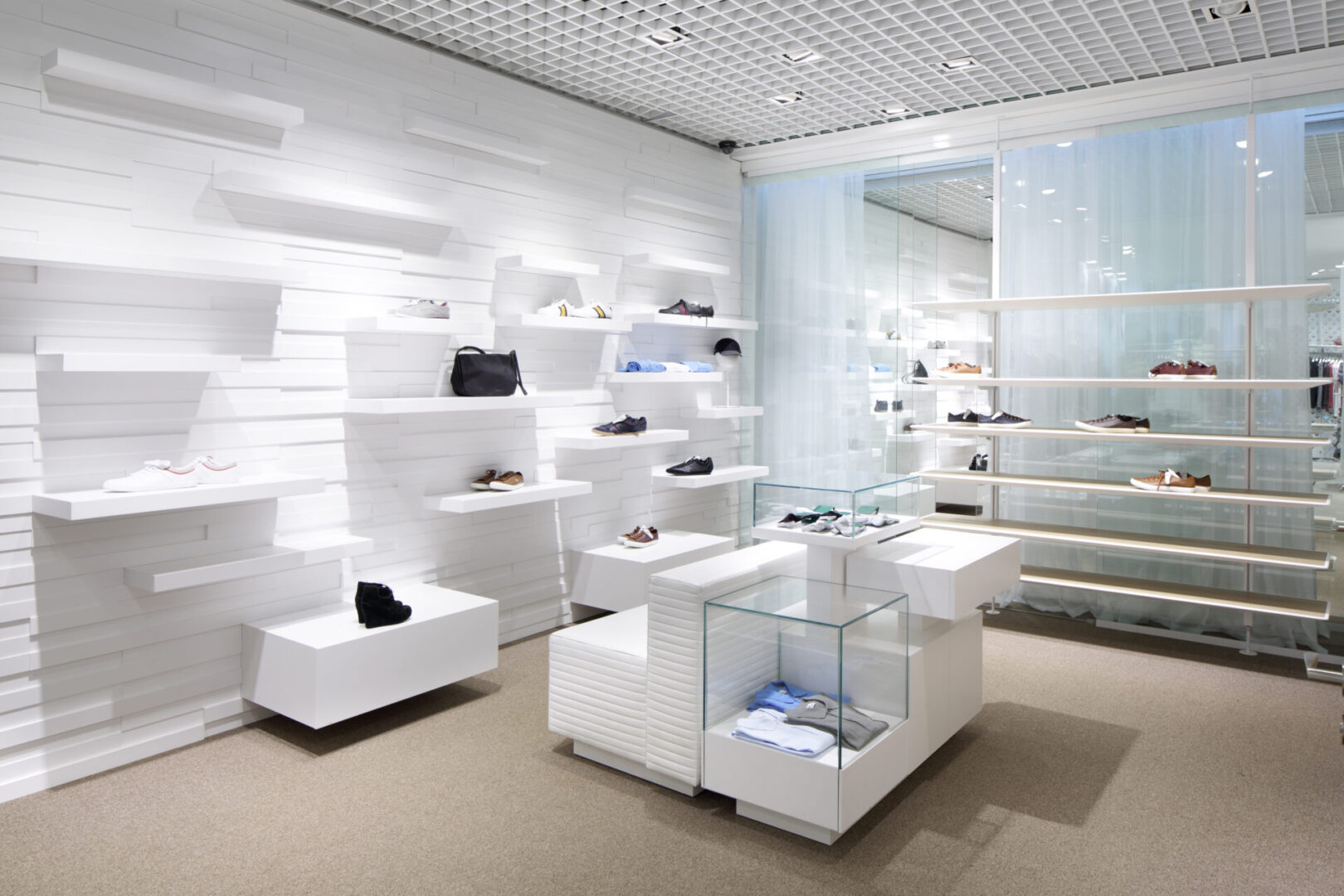 A white store with many shelves and tables