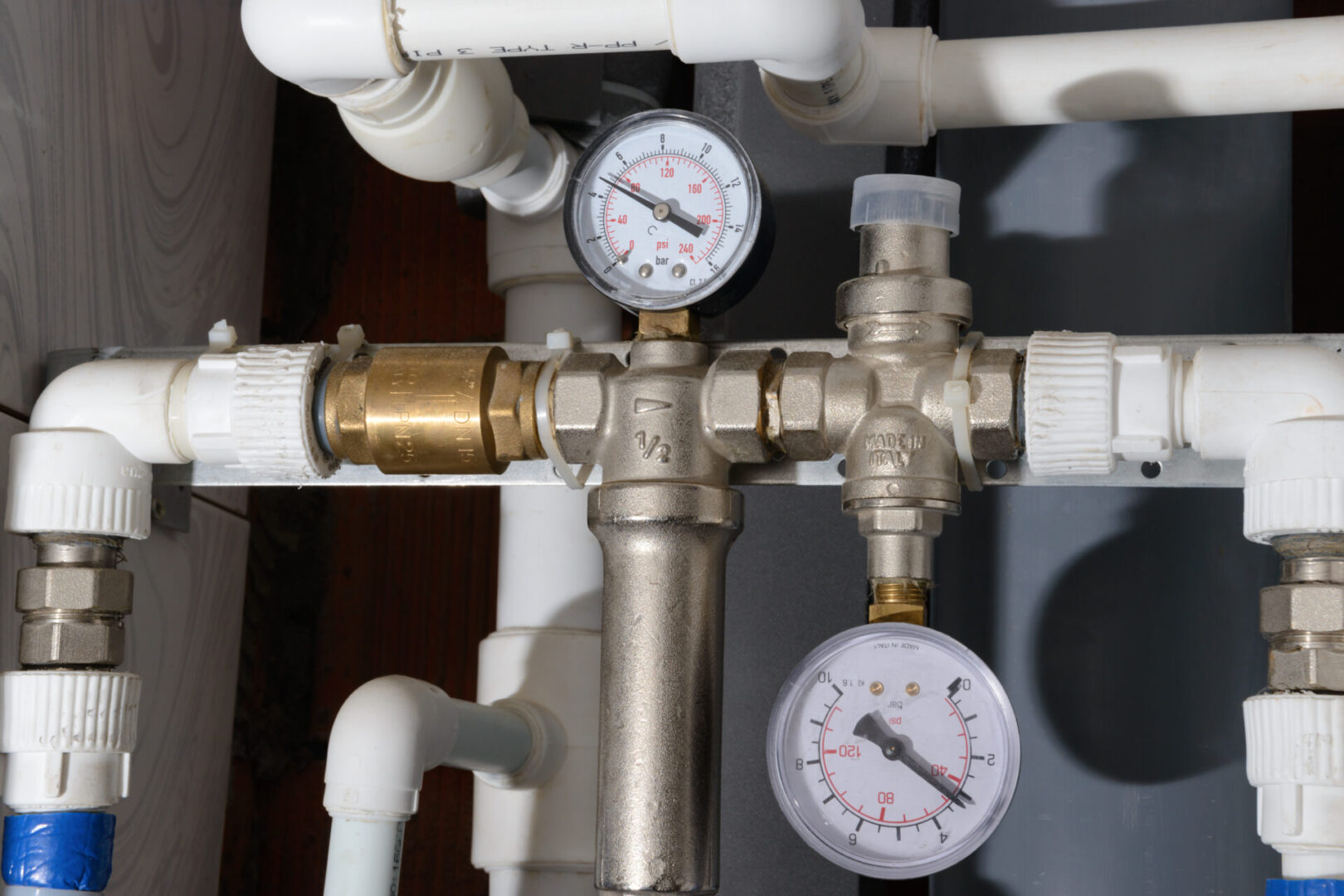A close up of pipes and valves with gauges