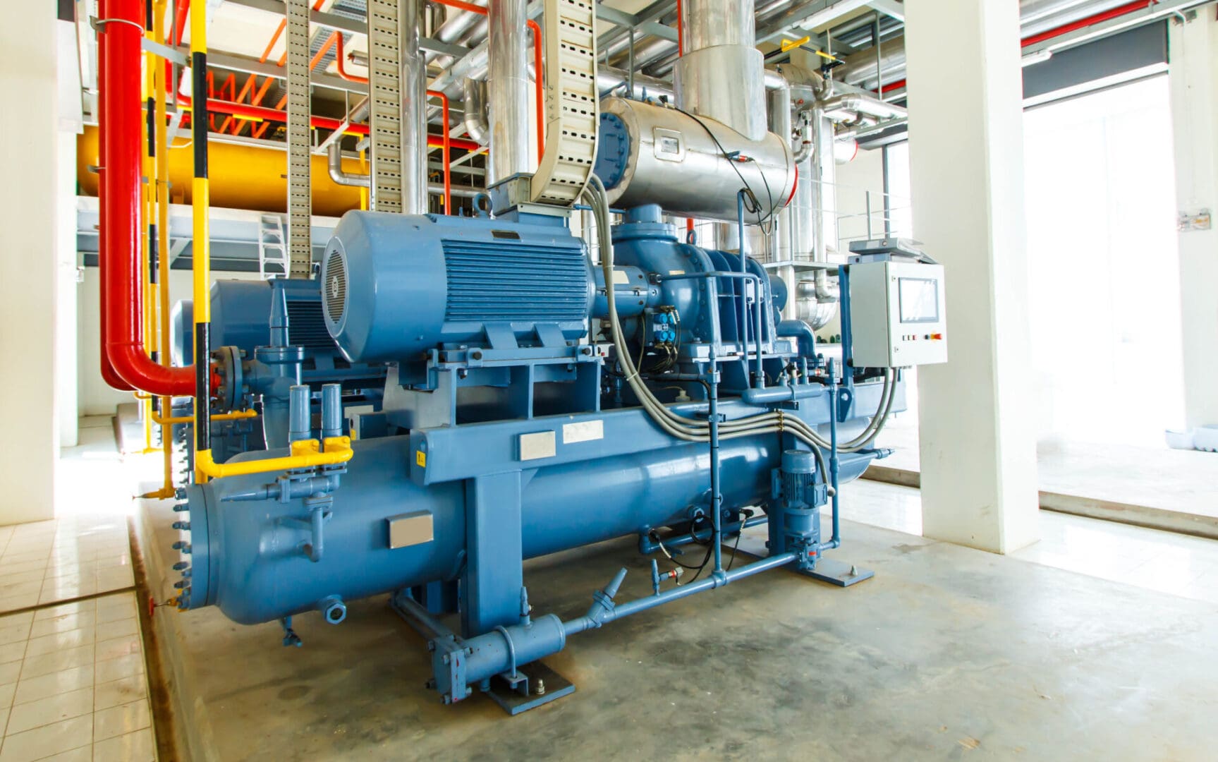 A large blue machine in a factory room.