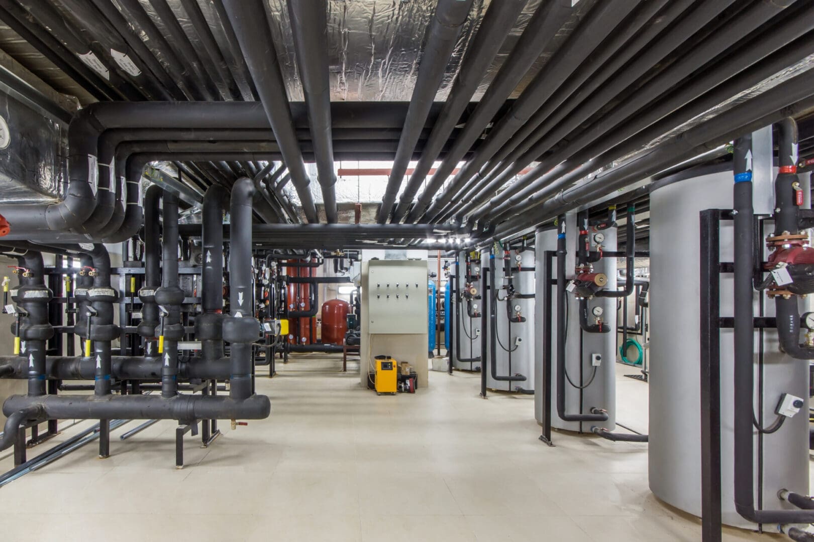 A large room with pipes and equipment in it.