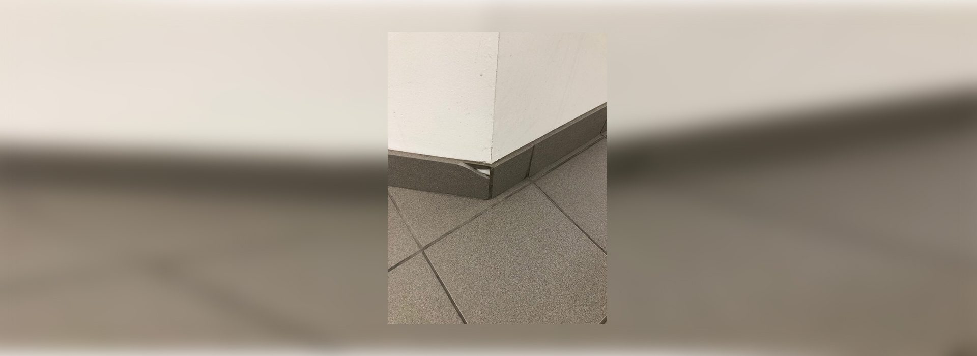 A corner of the floor with a metal edge.