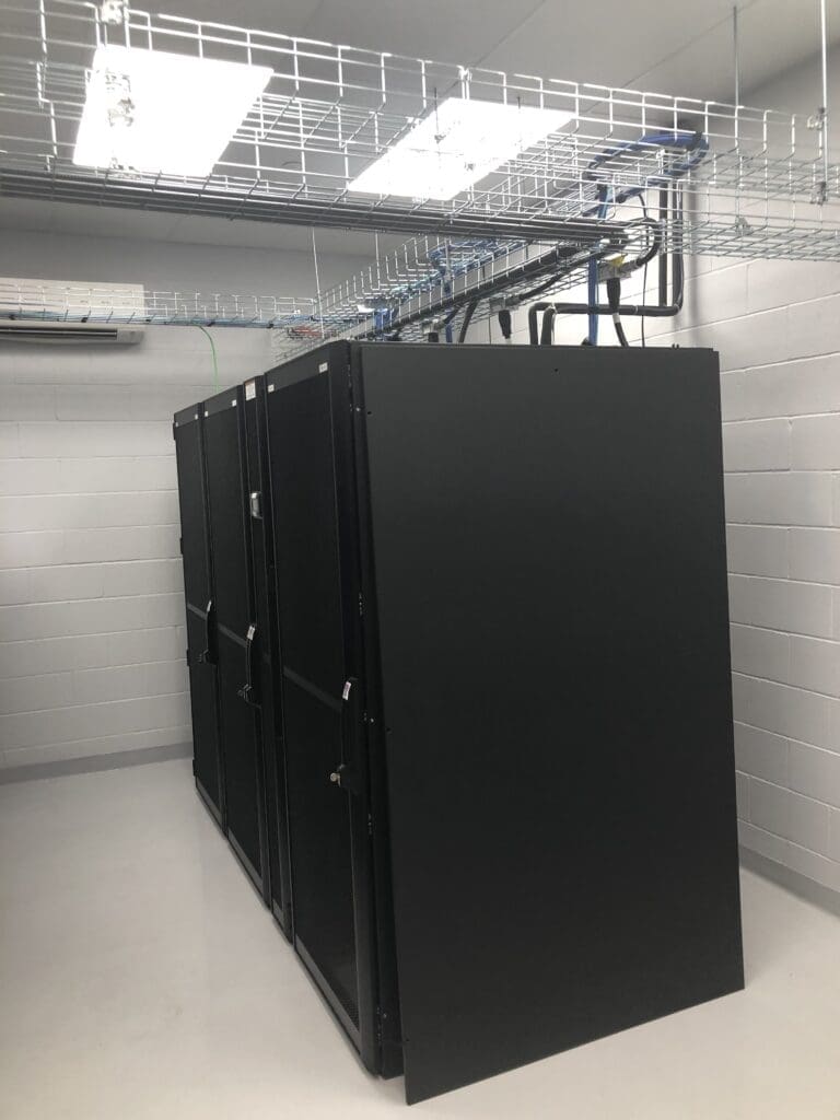 Black server racks in a data center.