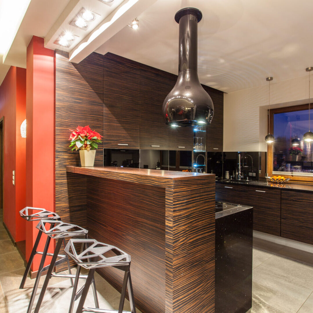 A kitchen with a bar and stools in it