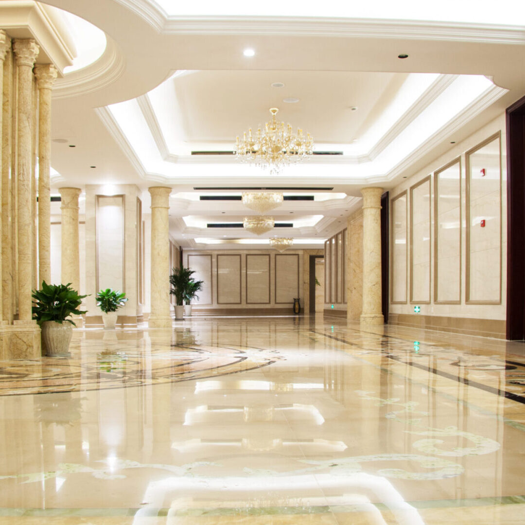 A large hallway with pillars and lights in it
